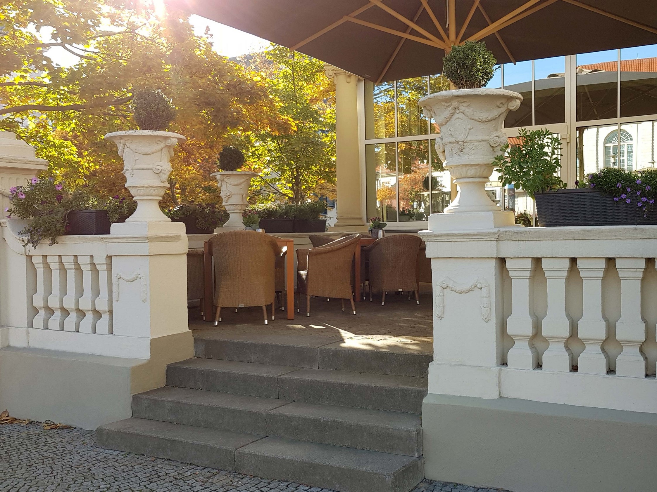 The terrace of the hotel with comfortable wicker armchairs and colorful flower boxes.